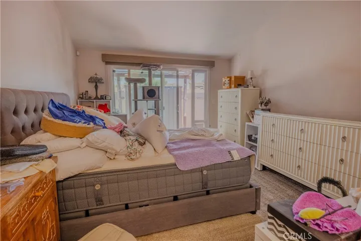 Primary bedroom has a sliding door to the backyard