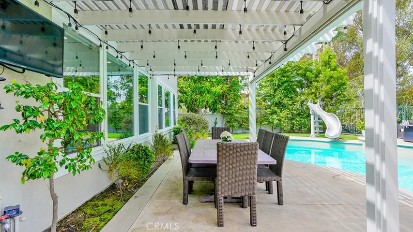 Outdoor seating with Pergola featuring roll down shades + Bistro lights
