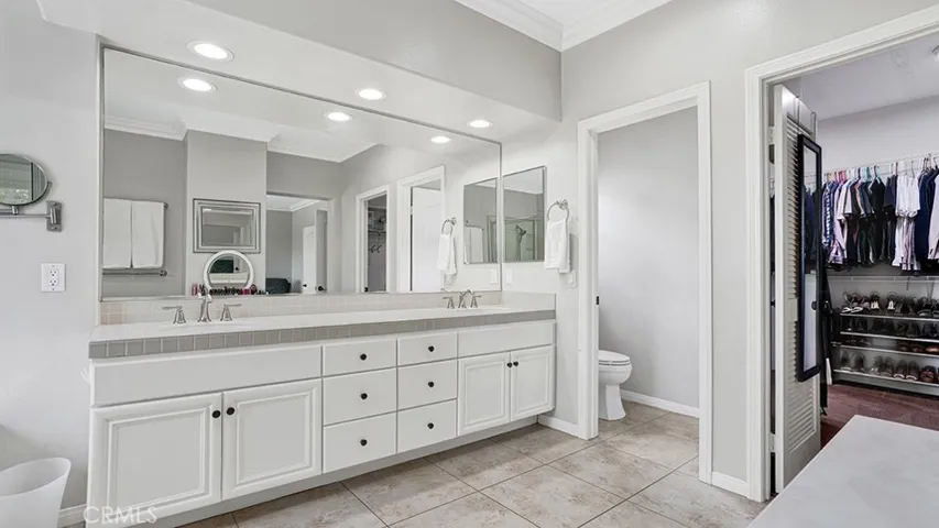 Master Bathroom - Dual Vanities + Doored Wash Room & Entrance to large closet.