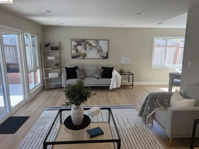 Open-concept living area featuring light wood-finish flooring, recessed lighting, and neutral wall tones