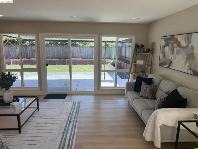 Living area featuring wood-finish flooring, recessed lighting, and neutral wall tones