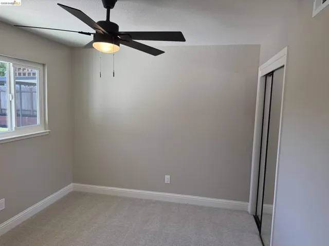 Neutral-toned walls complement plush carpet flooring