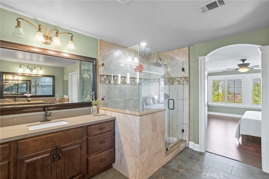 Expansive walk-in shower and generous vanity create a spa-like retreat