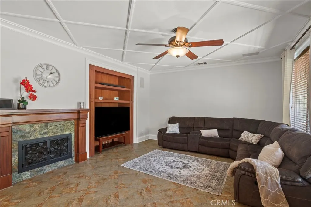 Custom built-ins and a stone-accent fireplace anchor this inviting family room