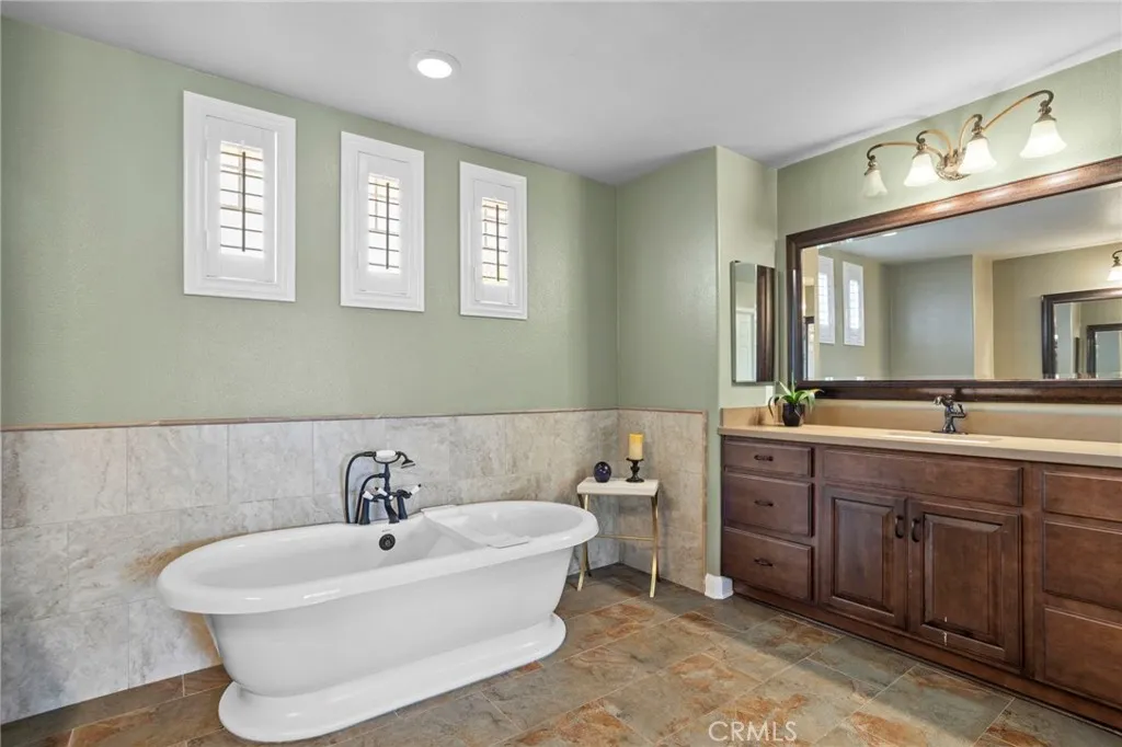 Spacious primary bathroom features a relaxing soaking tub