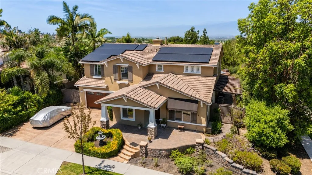 Framed by mature trees and lush landscaping, the home offers standout curb appeal