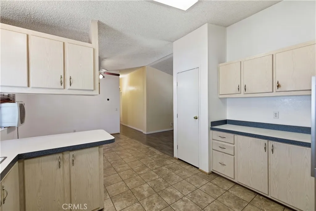Kitchen looking down hallway to guest rooms and bathroom