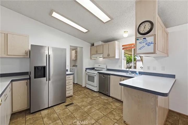 Kitchen leading to hall with laundry and carport entry