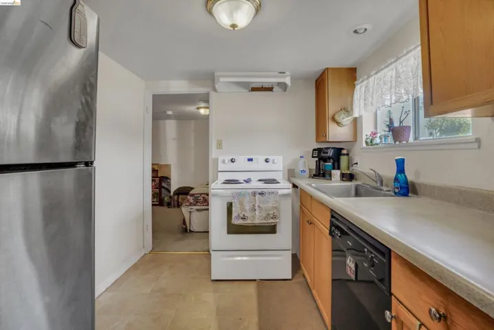 Kitchen featuring wood cabinetry and a stainless steel refrigerator