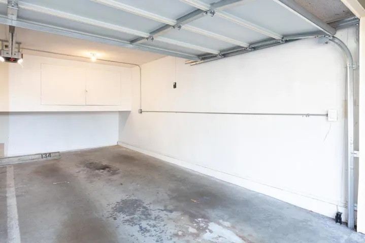 One car garage with storage and green permit for guest parking at green permit parking spots .