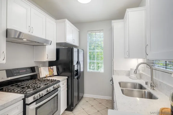 Kitchen features a large pantry and under-cabinet lighting.