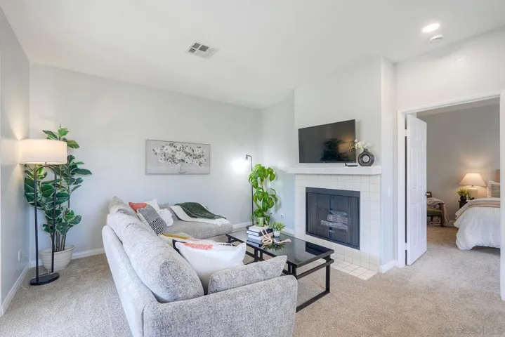 Spacious and bright - the living room has a TV already mounted plus a gas fireplace.  There's an alcove for additional storage.