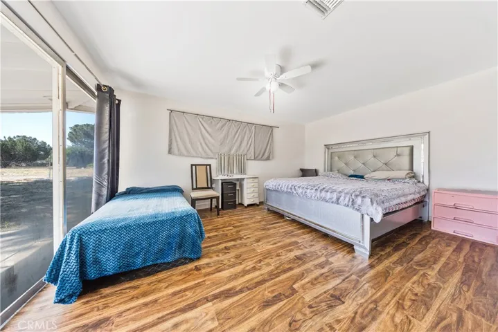 Secondary bedroom with abundant natural light & Sliding door with direct access outside.