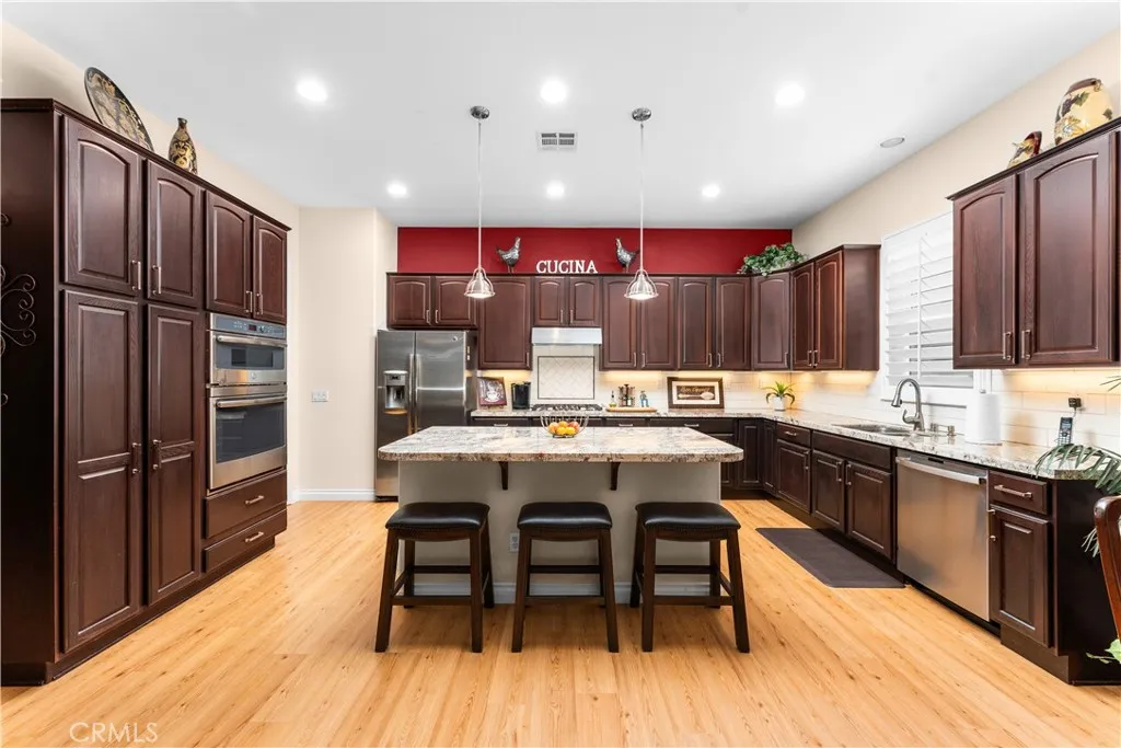 Island Kitchen with Brazilian Granite Countertops and Tiled Backsplash