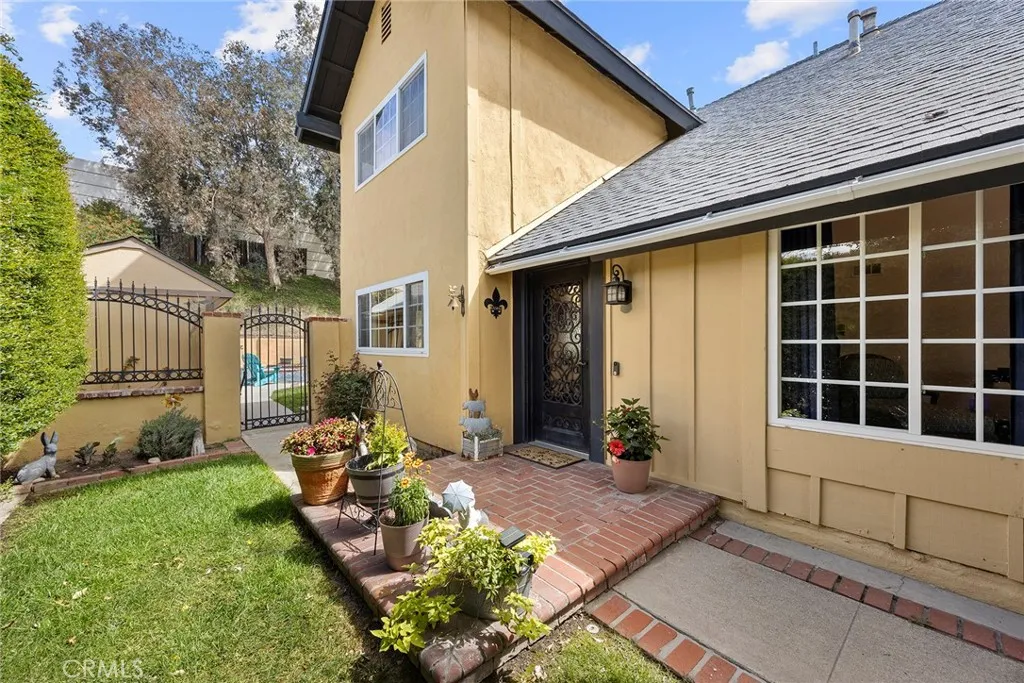 Entrance  through the side with custom wrought iron front door