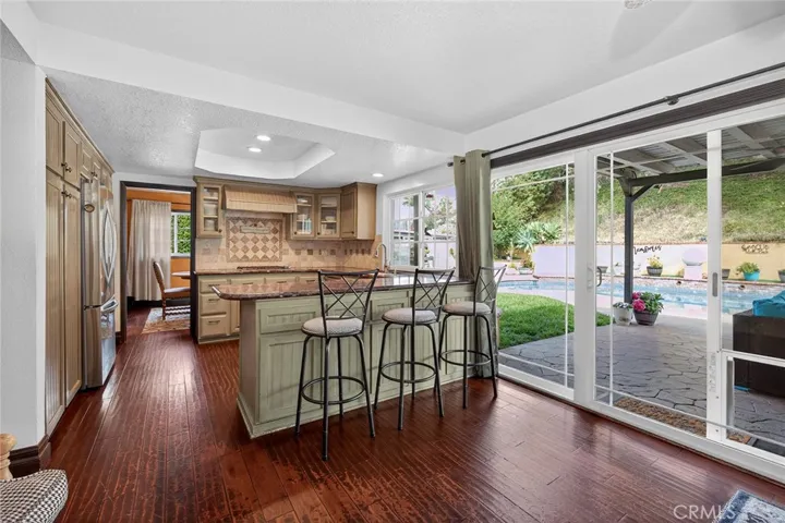 Family Room open to the kitchen with a pool view