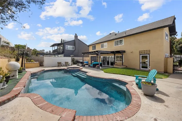 pool area. The garage door on the left is a drive through garage for the car enthusiast and dirfect access to the backyard