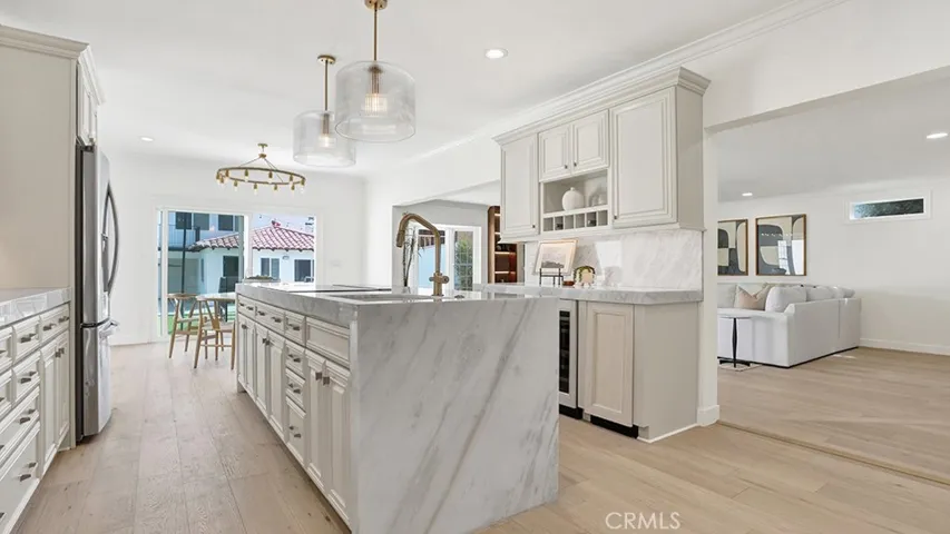Oversized center island with waterfall stone and fluted walnut detail.