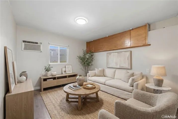 Virtually staged garage-converted living area showcasing a comfortable bonus lounge space designed for relaxation and entertaining.