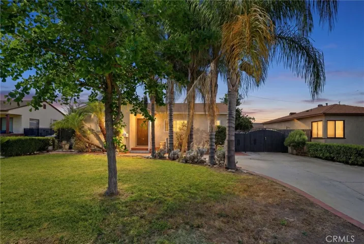 Curb appeal on point—lush landscaping and instant charm.