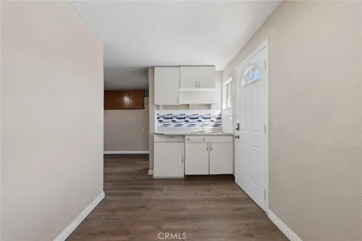 Converted garage bonus space featuring a small kitchen area and dining space, offering flexible use for guests, work, or extended living.