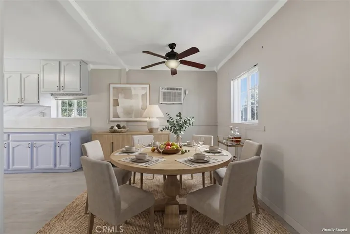 Virtually staged dining room highlighting the open-concept flow between the living room and kitchen.