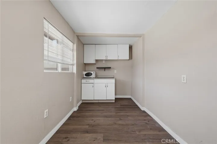 Converted garage bonus space with a small kitchen and dining area, providing flexible living options.