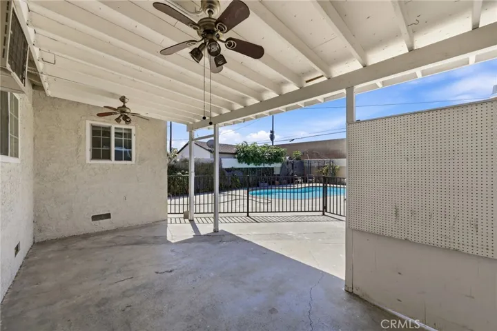 Covered backyard patio offering a comfortable outdoor living space, perfect for relaxing or entertaining year-round.
