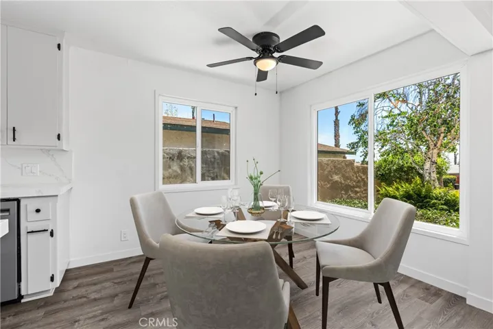Dining area off kitchen.  Big windows with lots of natural light.  Digitally enhanced photo.