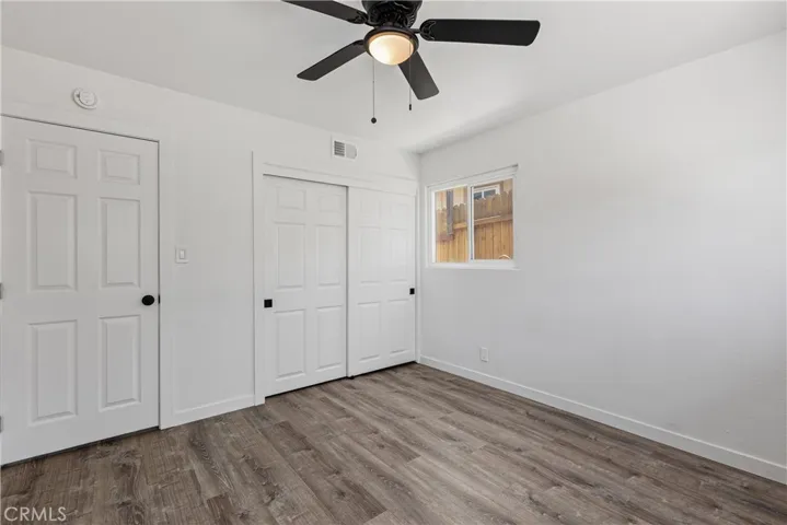 Secondary bedroom with new flooring, closet and doors.