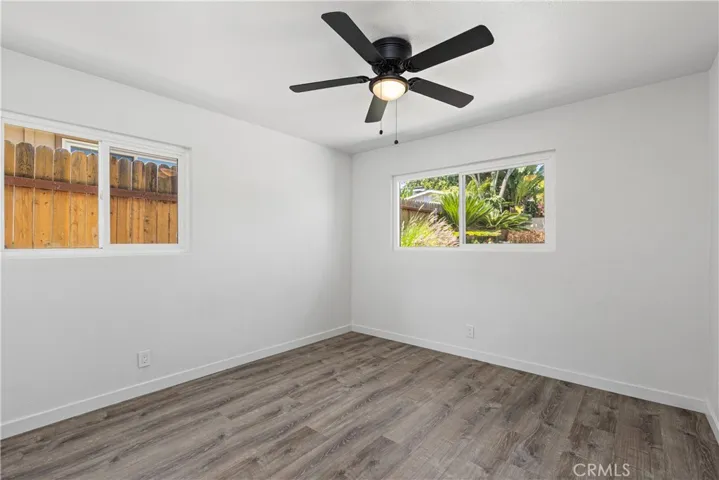 Secondary bedroom with new flooring.  Light and bright with windows.