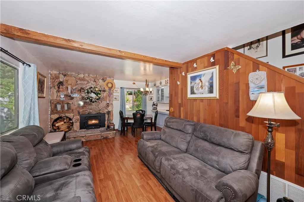 Family Room With Laminate Flooring And Fireplace Insert.

Fireplace has been digitally altered