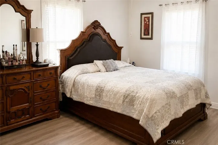 This image has been digitally enhanced to illiterate how the look and feel of the bedroom  can change with a new paint and flooring.