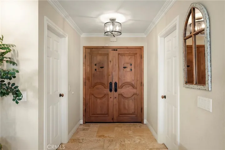 Welcoming foyer with custom wood double doors