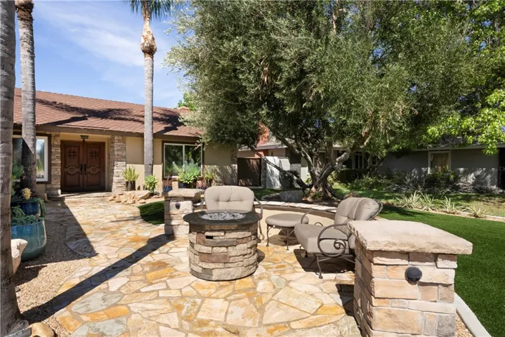 Beautiful courtyard with mature shade tree and built-in fire pit