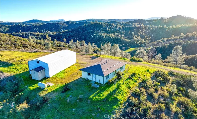 Presenting 19800 Cantwell Ranch Rd - nice areal view of the home and large barn/shop!