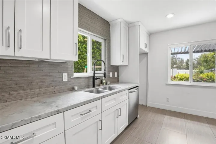 Kitchen views of backyard and patio