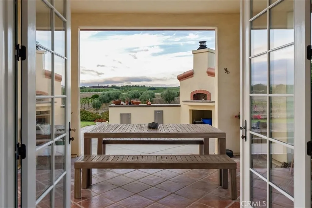 ...opens to the covered patio and outdoor kitchen...
