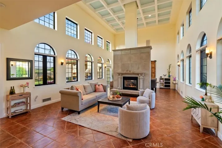 ...soaring coffered ceiling top the living area...