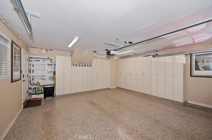 Garage with custom cabinets and epoxy floor.