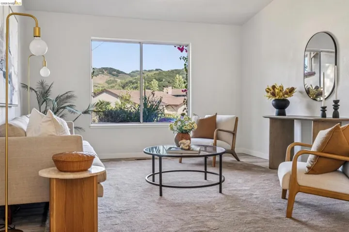 Living area with wall-to-wall carpeting and a large window