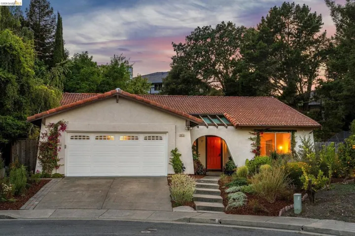 Mediterranean-style stucco exterior with a terra cotta tile roof