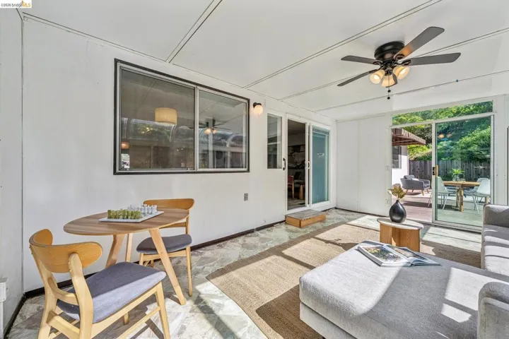 Sunroom with patterned floor tiling and white paneled walls