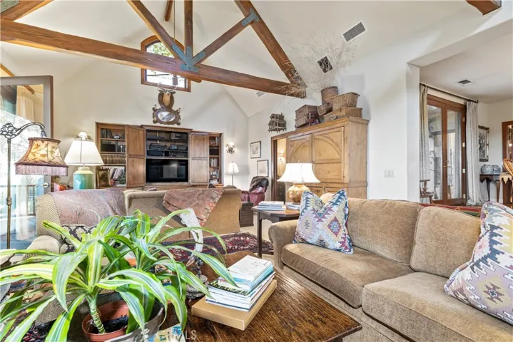 Large beams catch your eye in this oversized living room/ TV seating area.