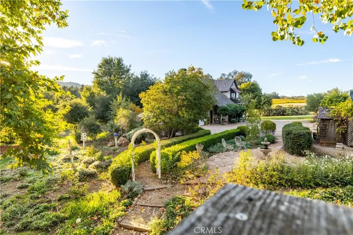 Well established landscape surrounds walkways between the main residence and the carriage house.