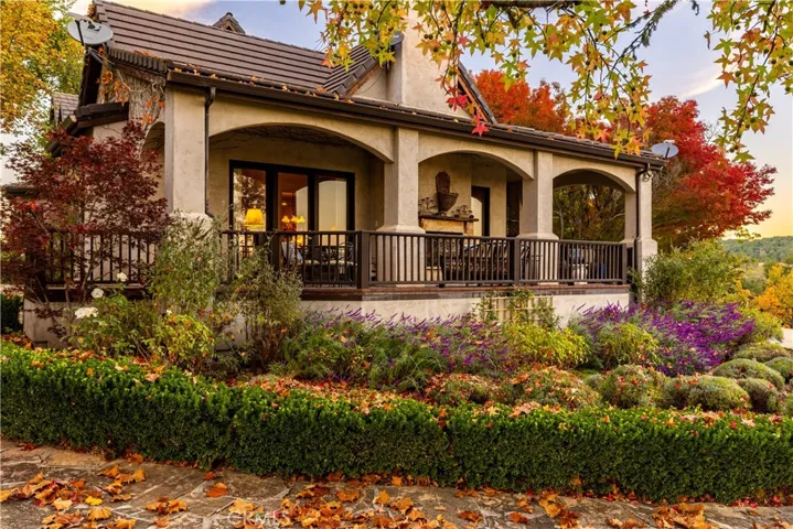 Landscape surrounds wrap-around porch on the South side of the house.