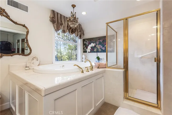 Soaking tub and walk-in tile shower.