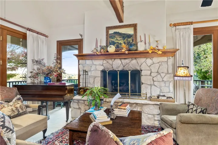 Living room with stunning fireplace and lots of windows to let in the natural light.