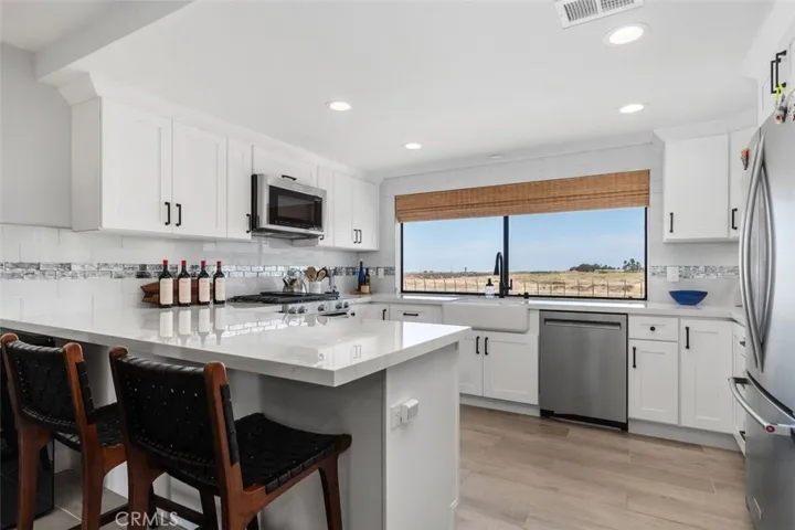 Upgraded Open Kitchen with natural light and a view of the amazing Randall Preserve.
