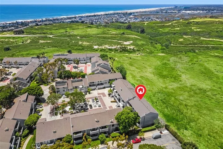 This drone photo shows that this location has an ocean and sunset view off the rear balcony while facing the Randall Preserve as this photo has been digitally enhanced for a greener open space.
